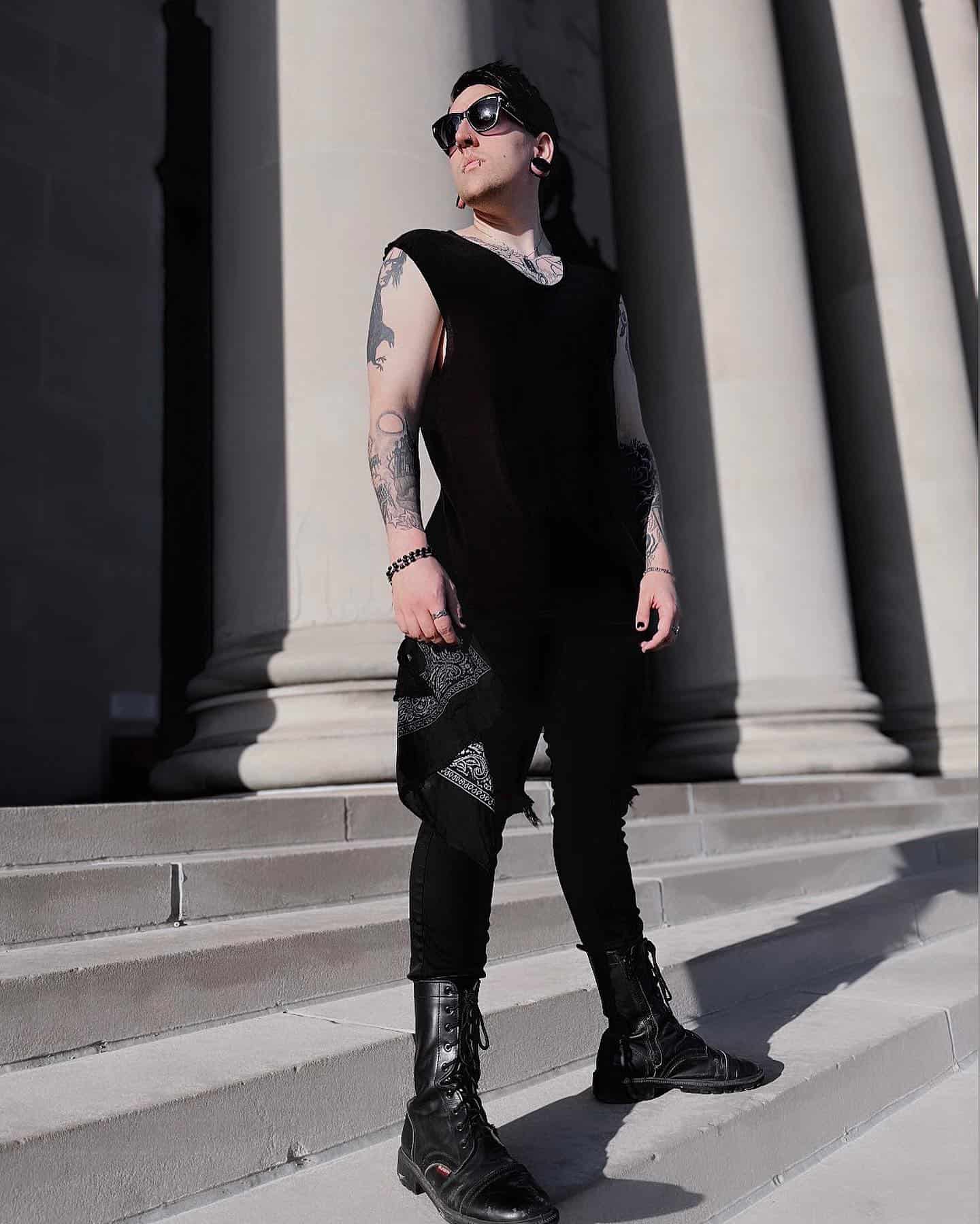 man with sunglasses wearing an all black goth outfit