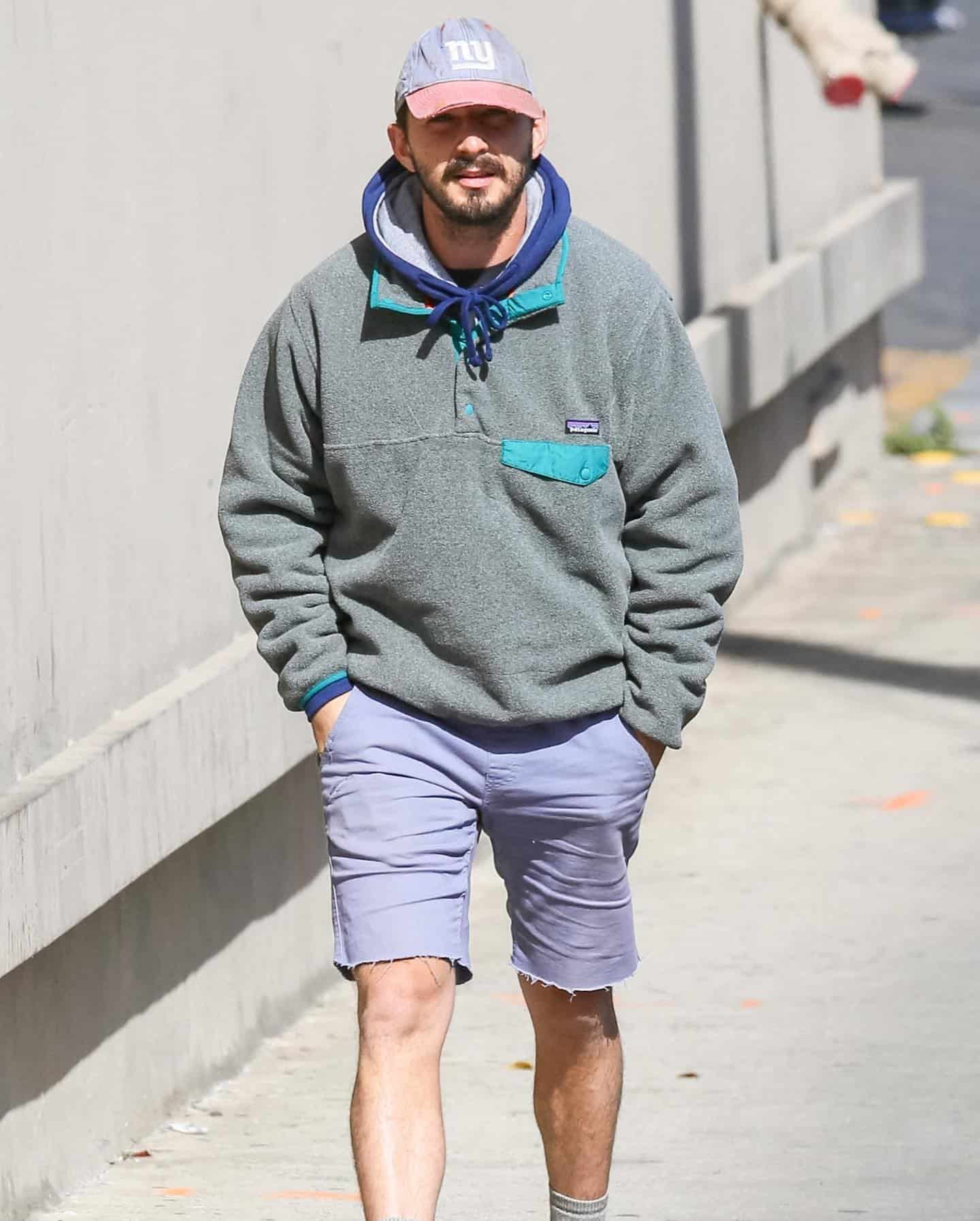 Shia LaBeouf in a fleece jacket and blue and red hat