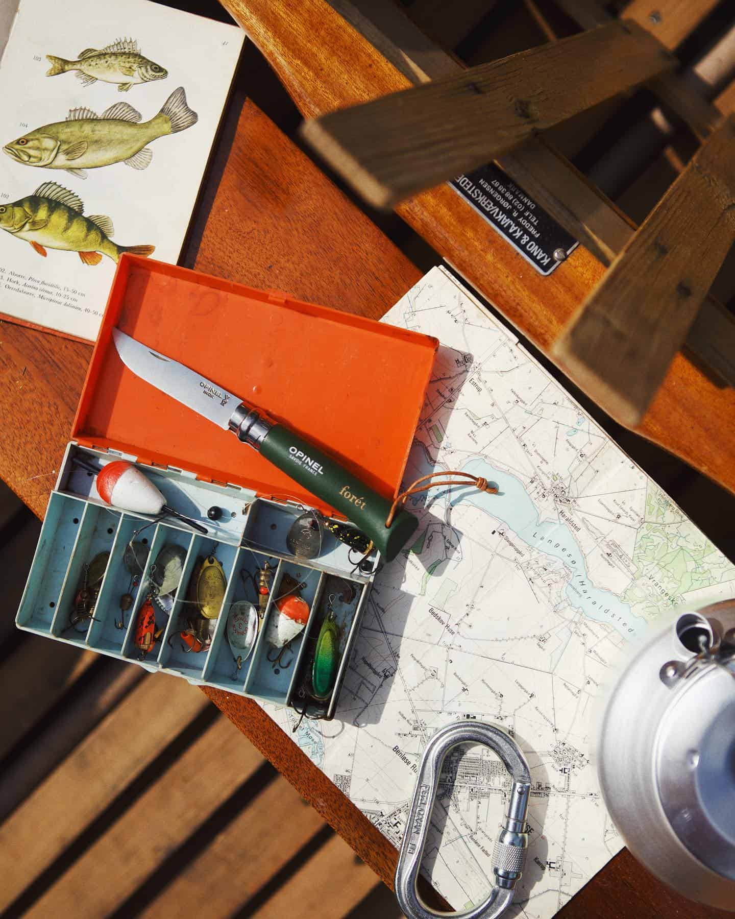 a set of fish bait and an opinel x foret knife