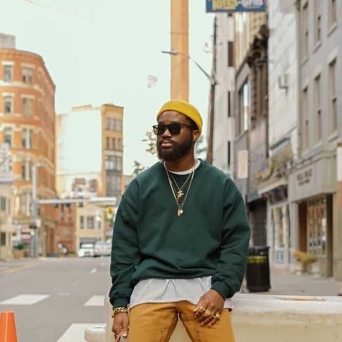 Hipster style: man wearing a yellow beanie and a green sweater
