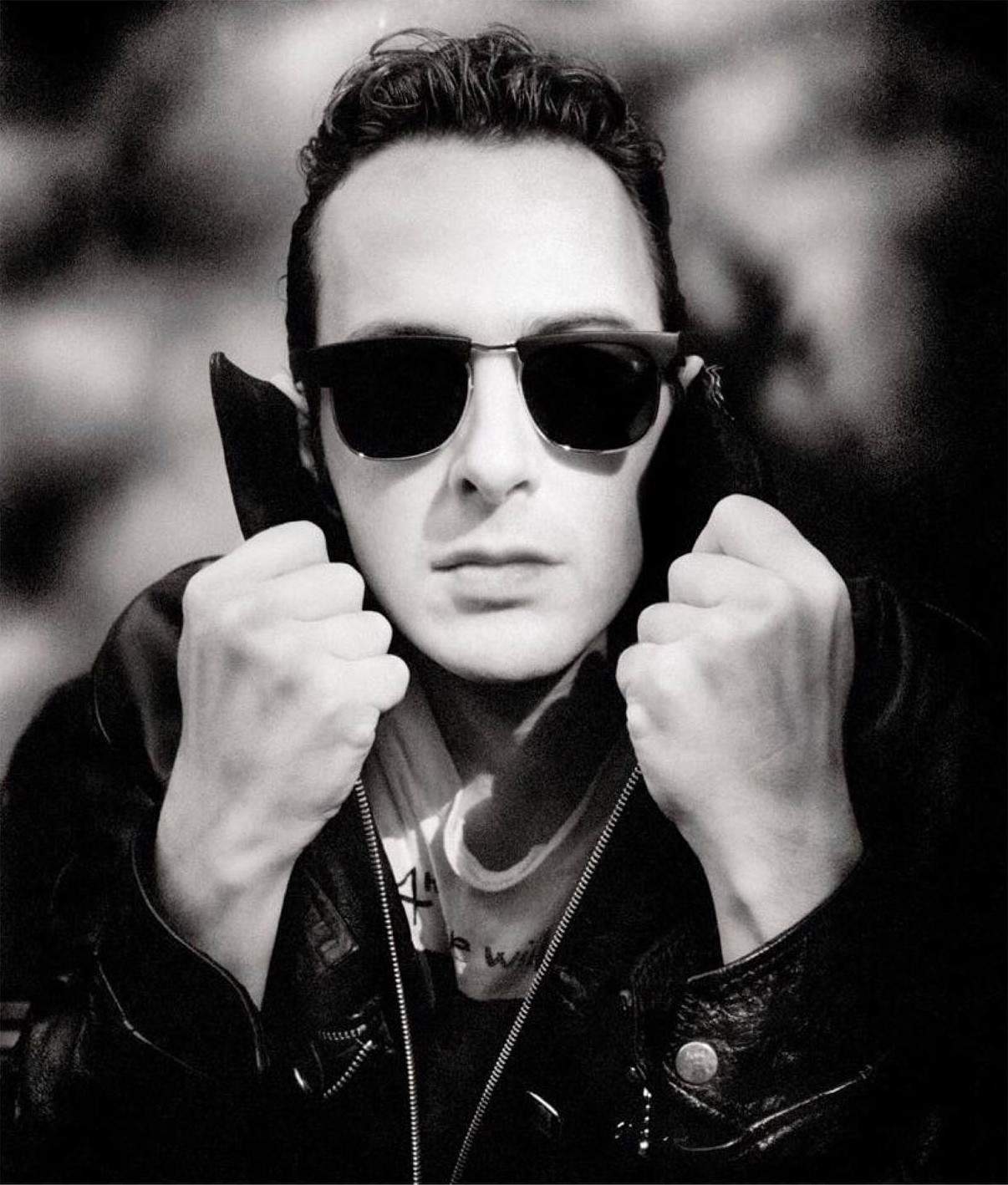 joe strummer wearing a biker leather jacket