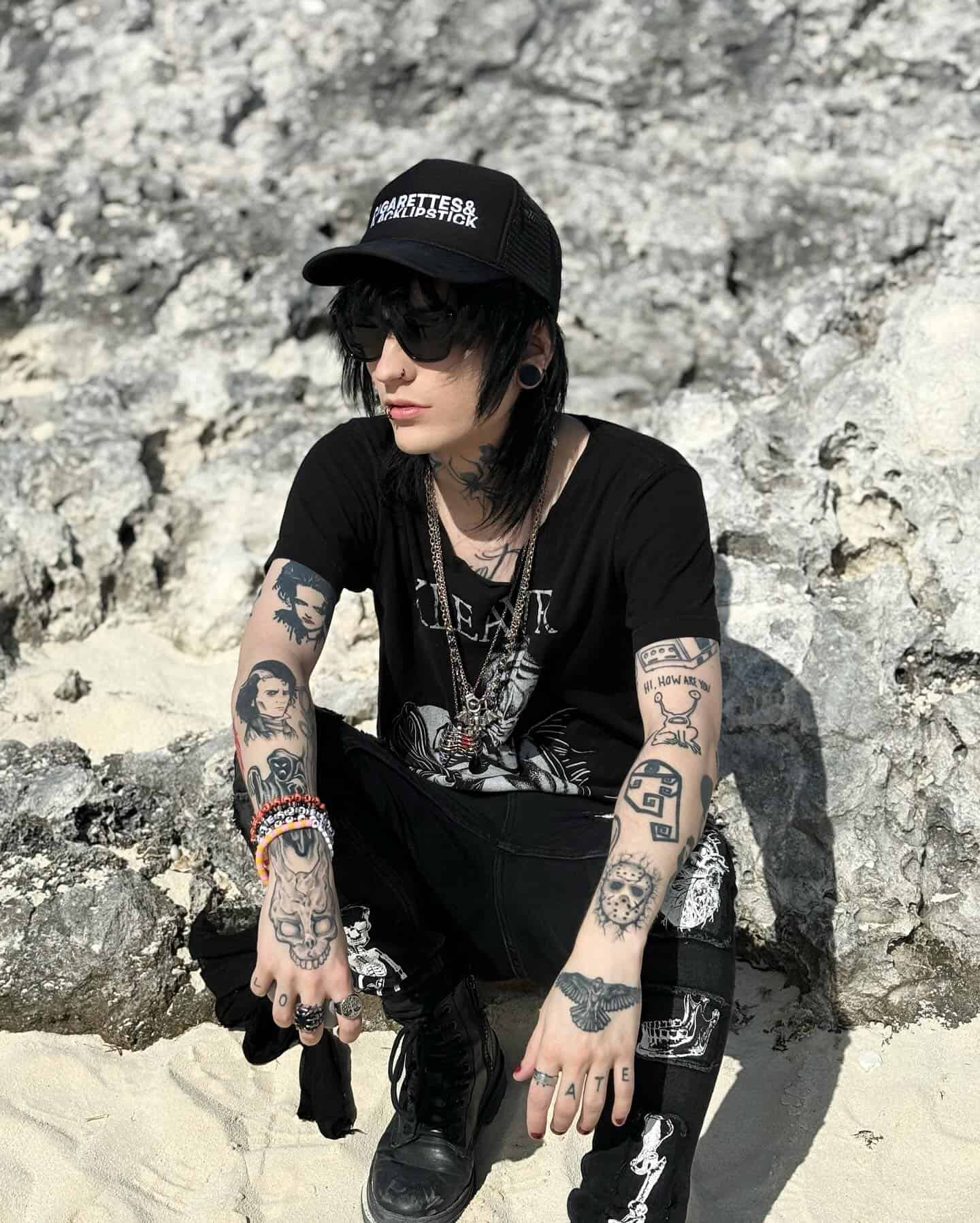 man in an all black outfit by the beach