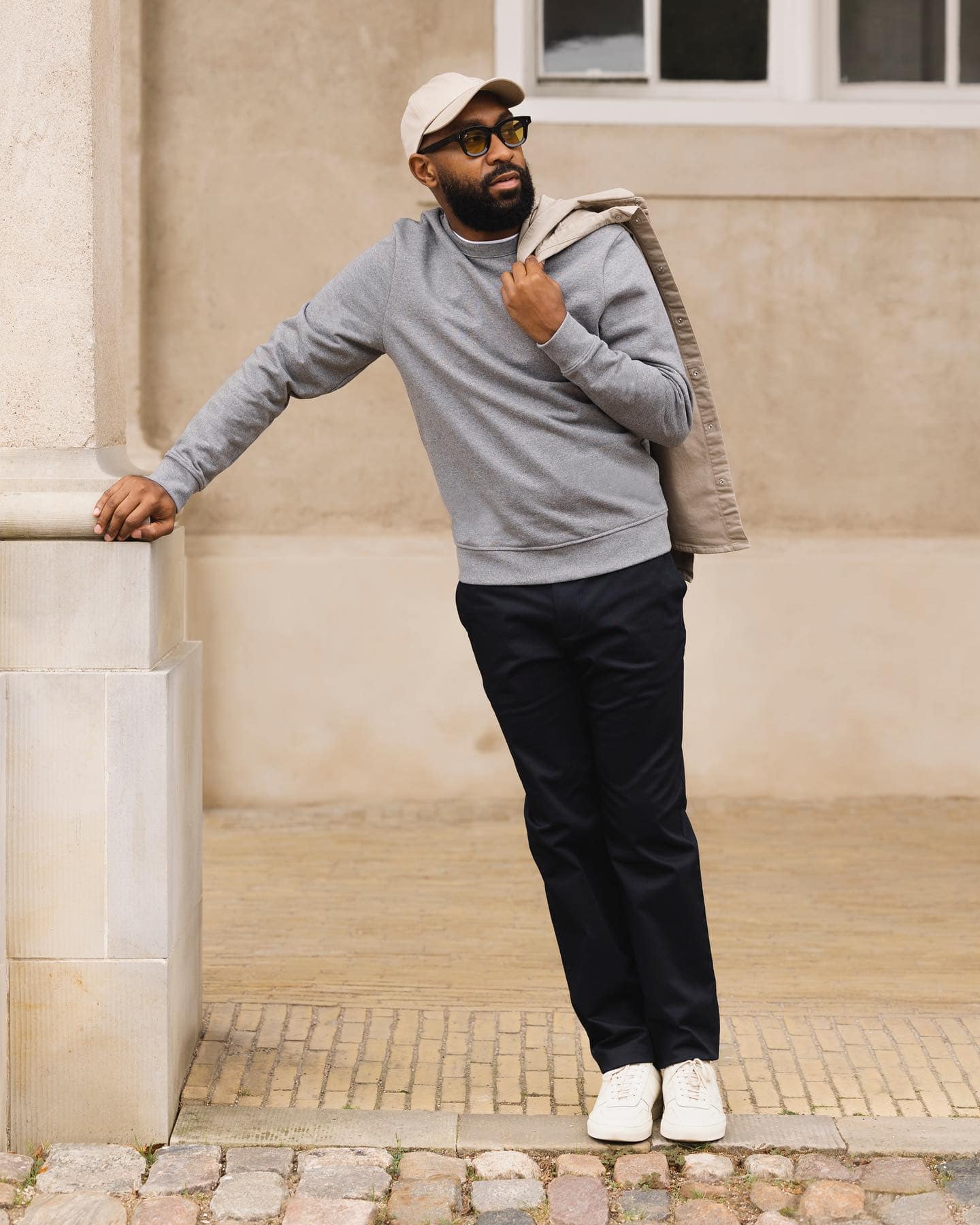 Minimalist style: man wearing a gray sweater and black pants