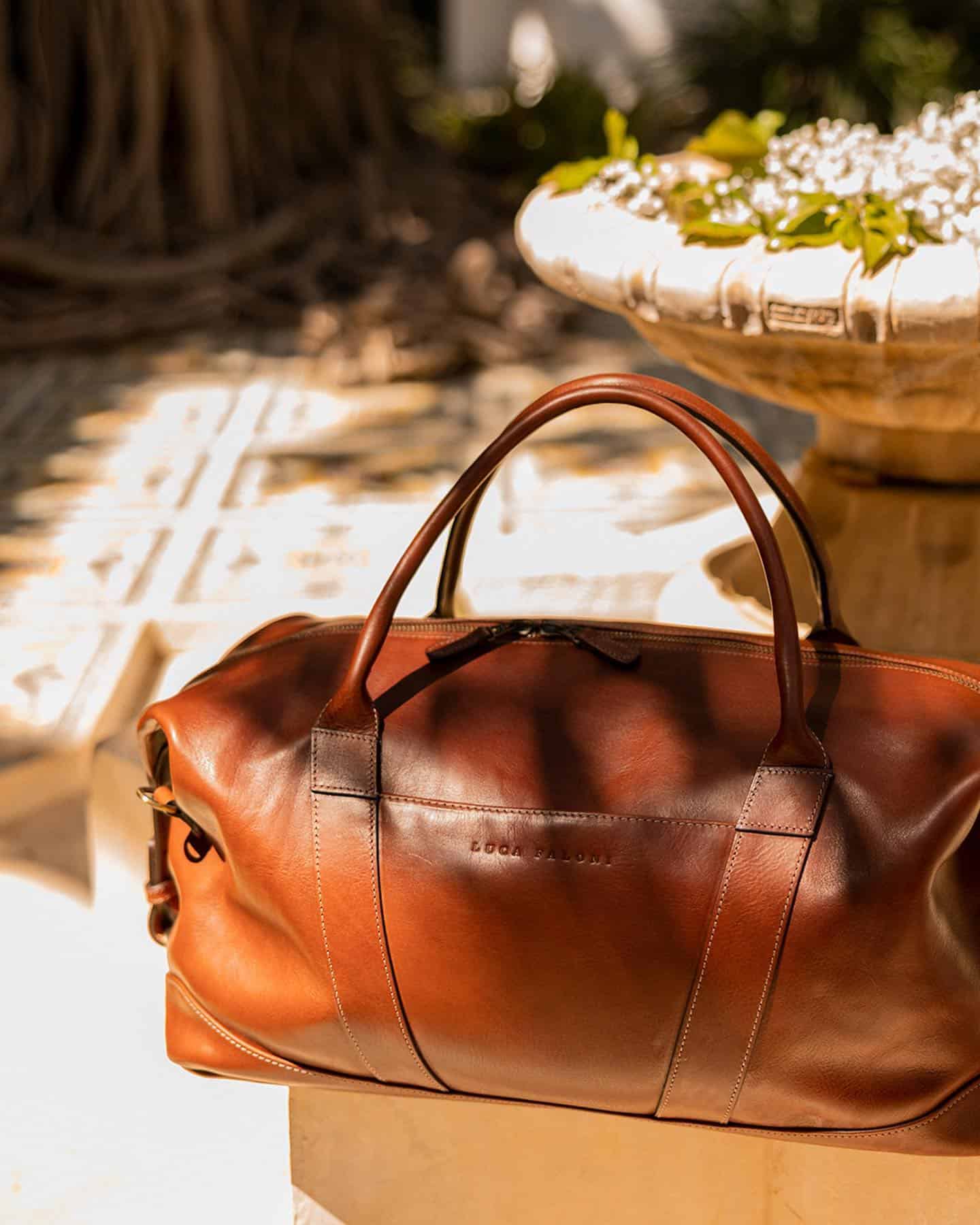 a leather weekender bag by luca faloni