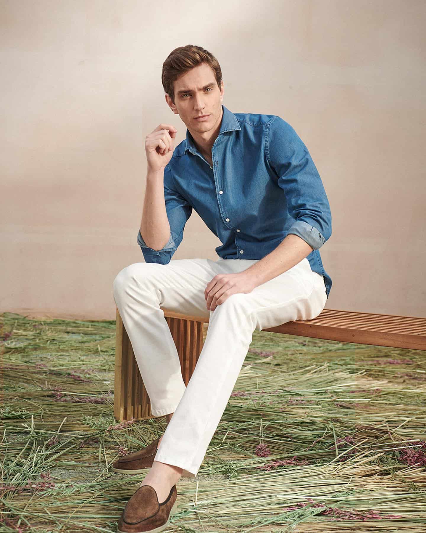 man wearing a denim shirt and white pants