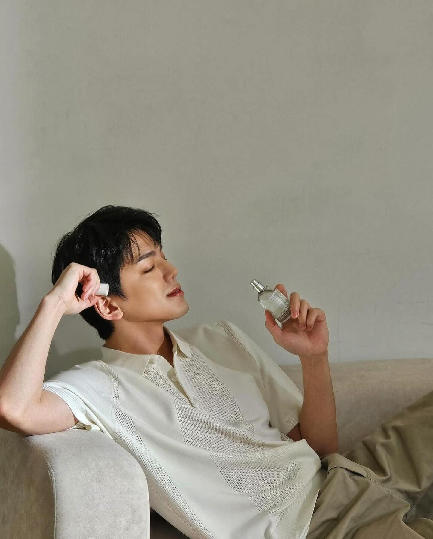 man smelling the scent of malin goetz dark rum cologne