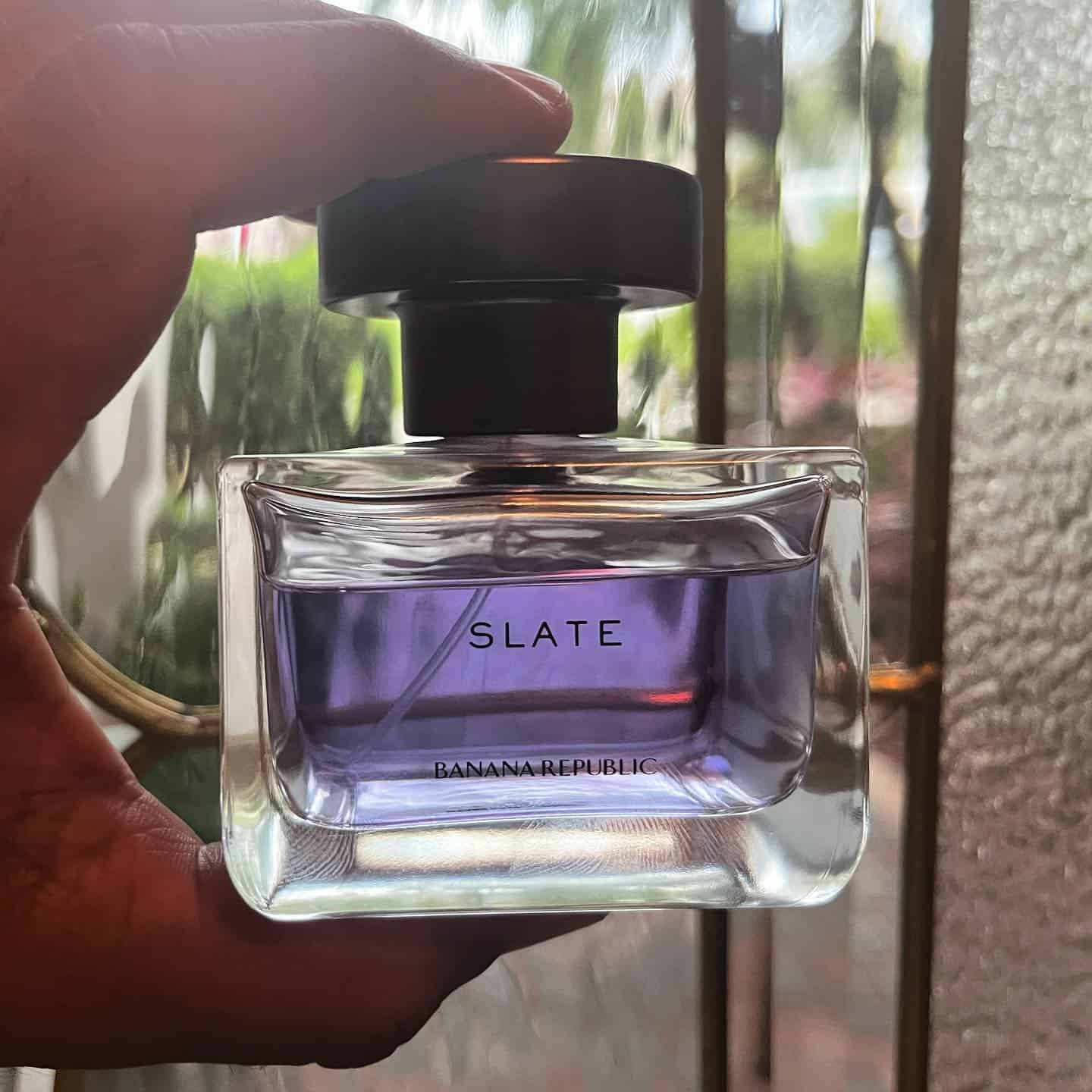 holding a bottle of slate cologne by banana republic