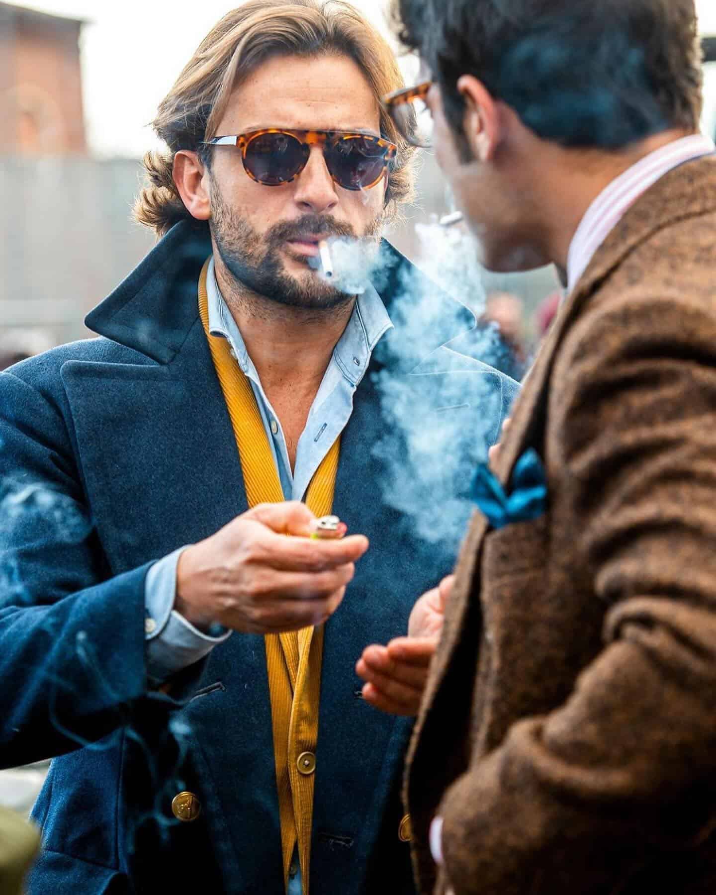 two men facing each other while smoking