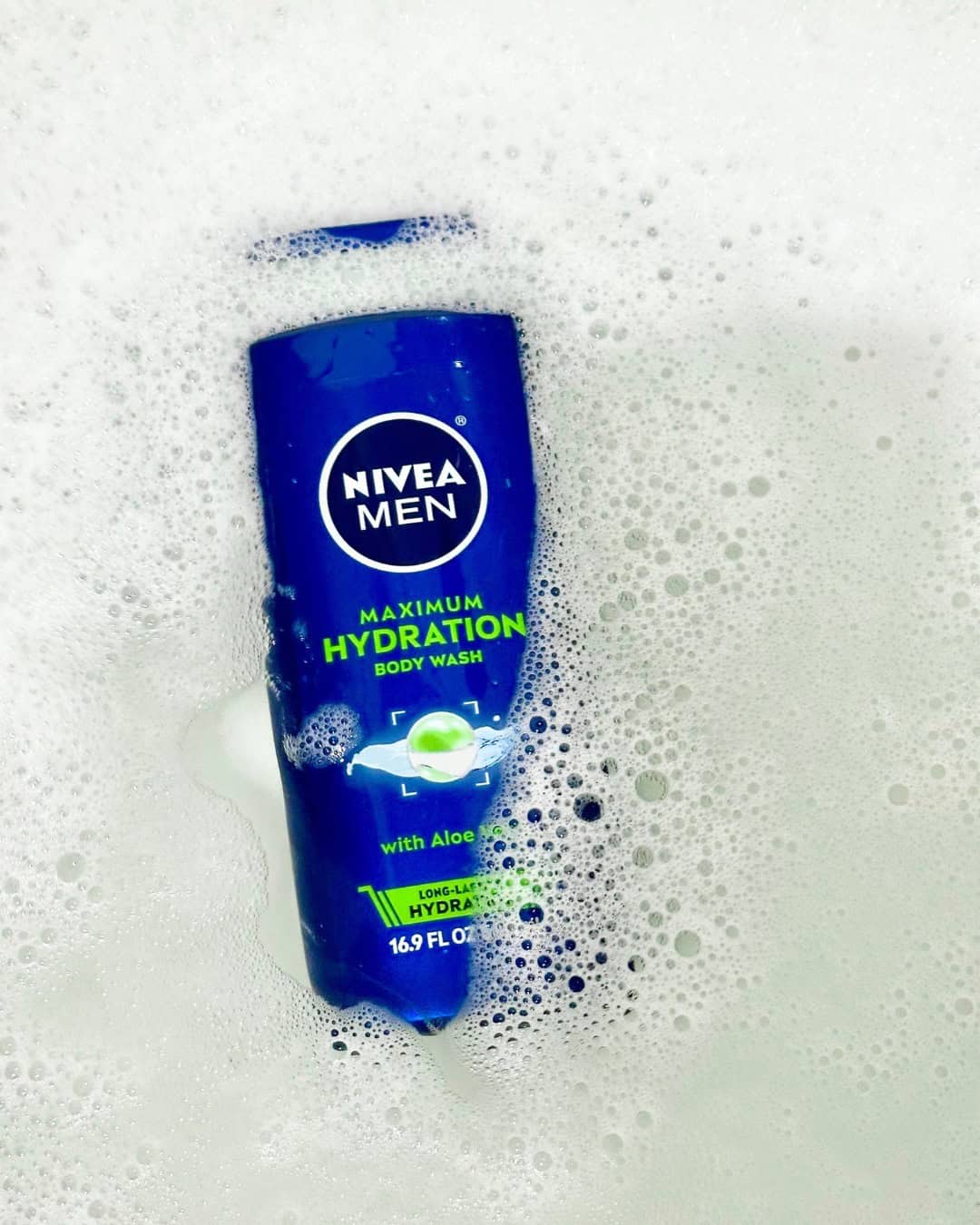 a bottle of nivea man body wash floating on foamy water