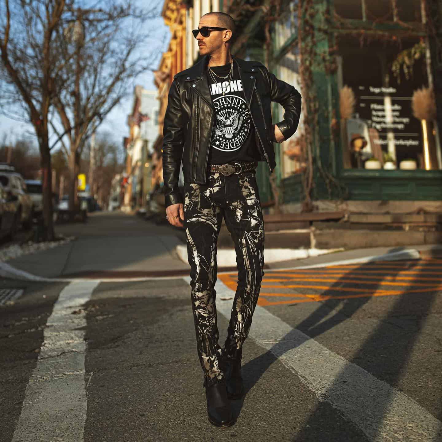 man wearing a punk style printed jeans