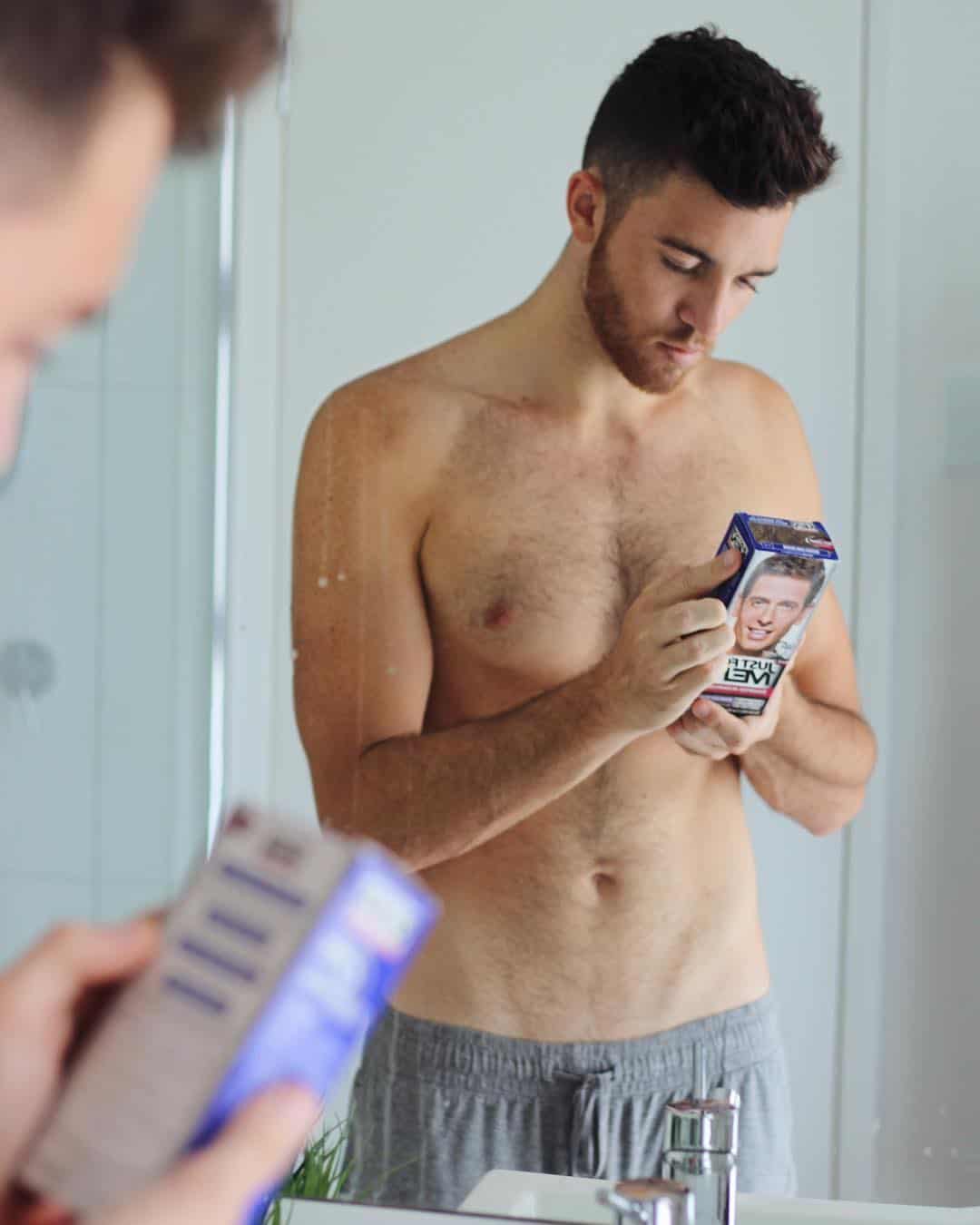 man checking the box contents of men first gradual gray shampoo