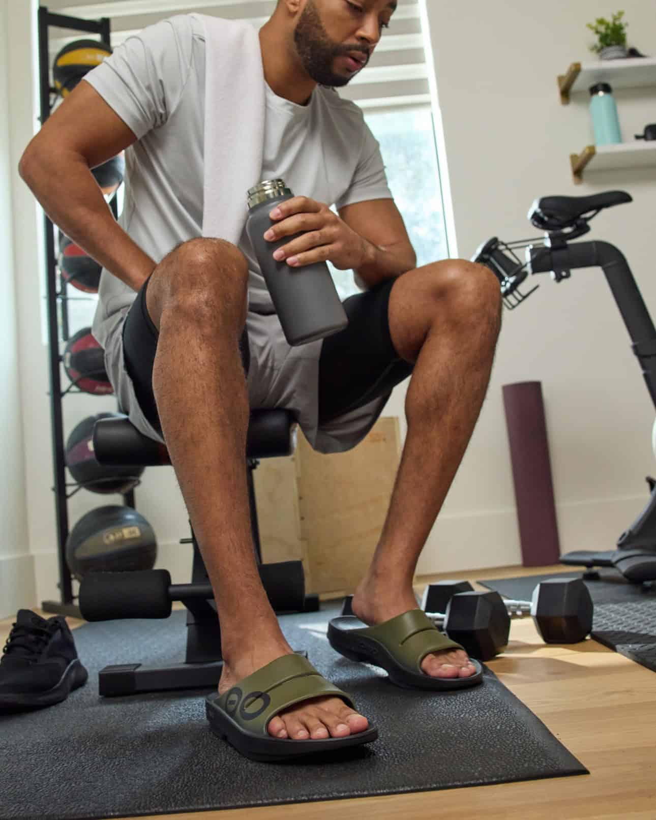 man wearing the OOahh Sports Recovery Slides by Oofos