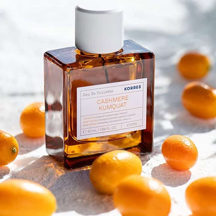 a bottle of cashmere kumquat surrounded with kumquat fruits