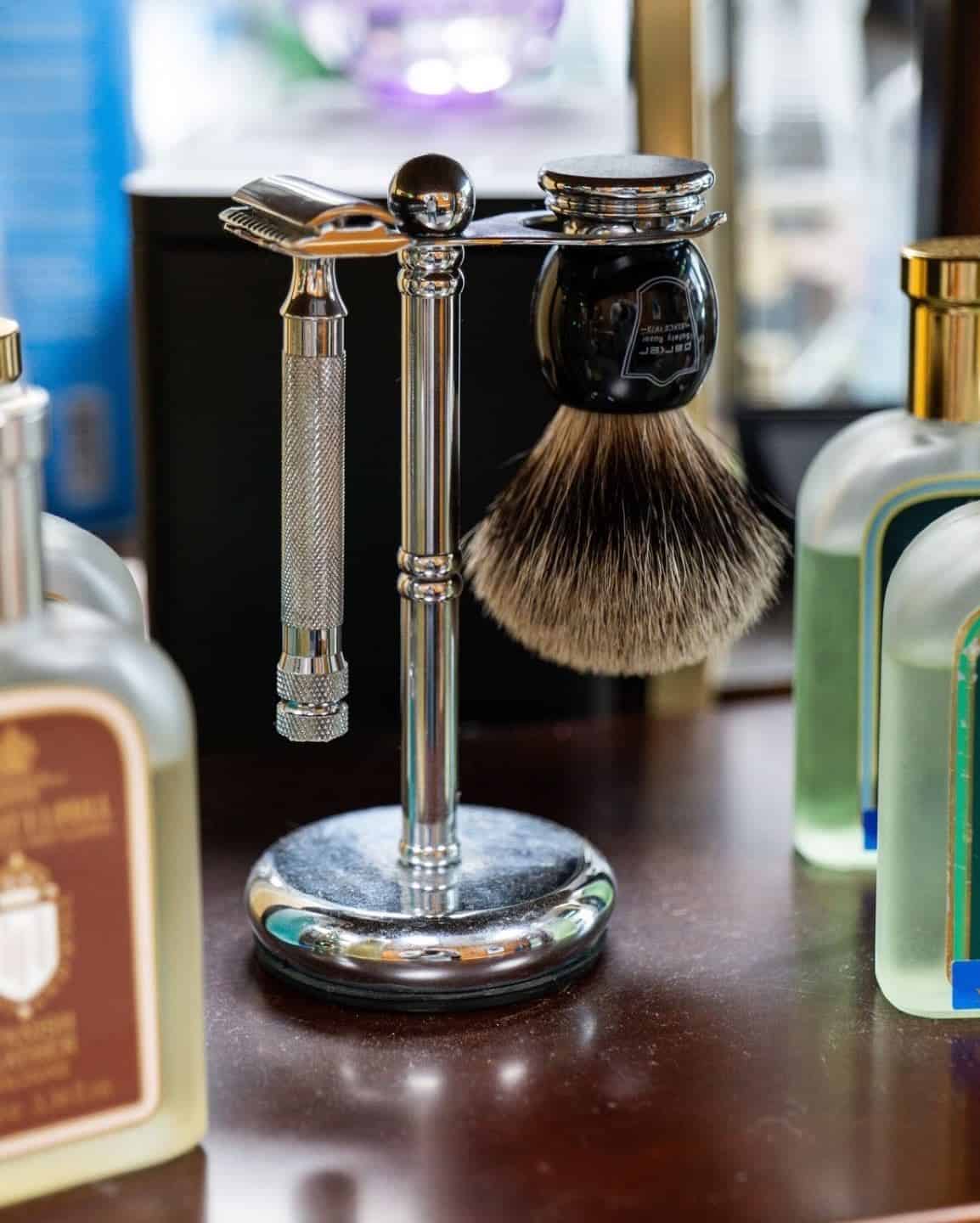 a shaving brush and safety razor on a stand by parker