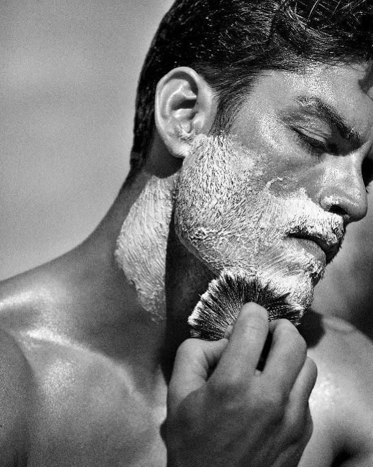 man applying a generous amount of lather on the face