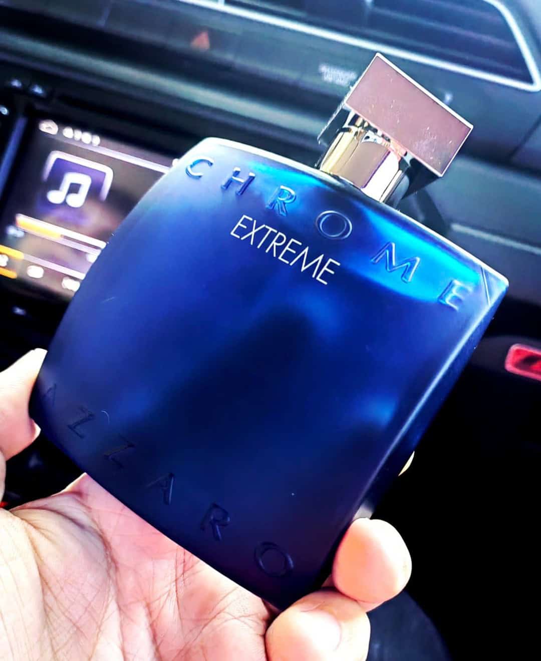 holding a bottle of azaro chrome extreme
