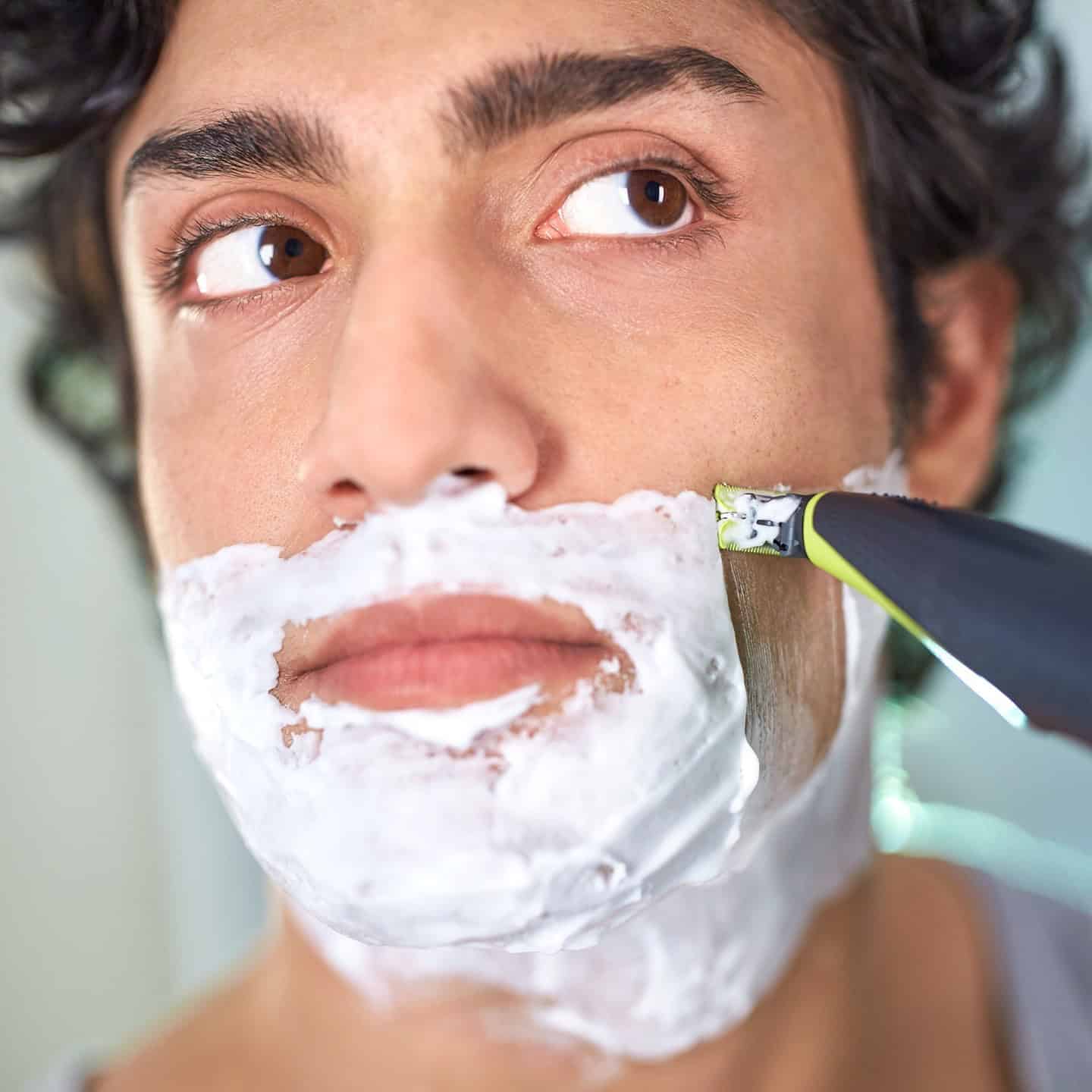 man using a philips norelco one blade for shaving beard