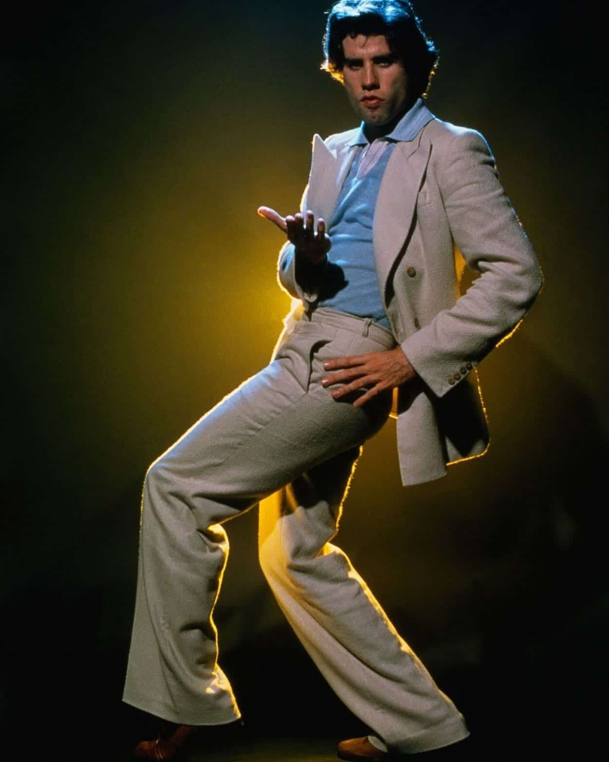 john travolta in a suit posing a dance move