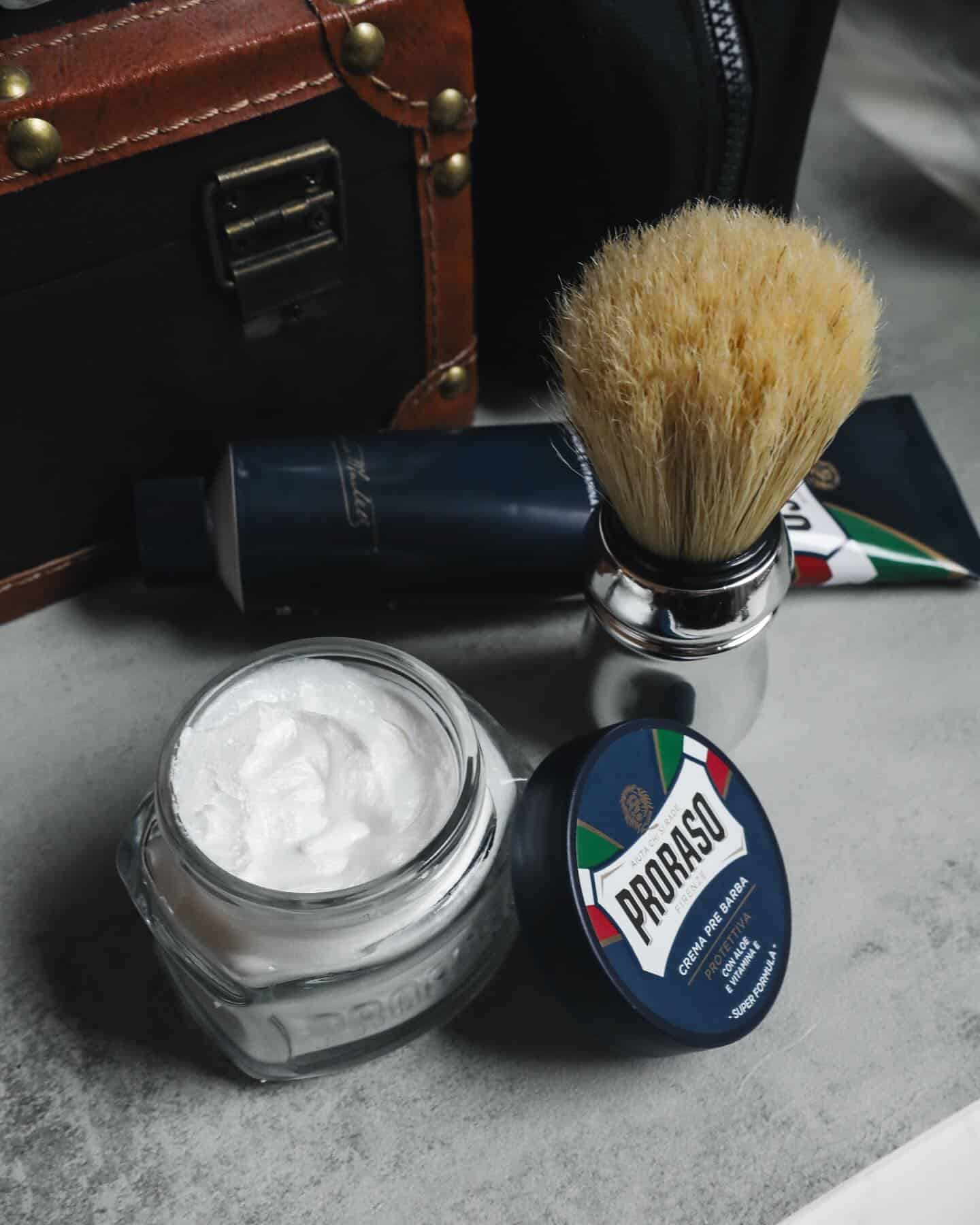 an open bottle of proraso shaving cream and shaving brush