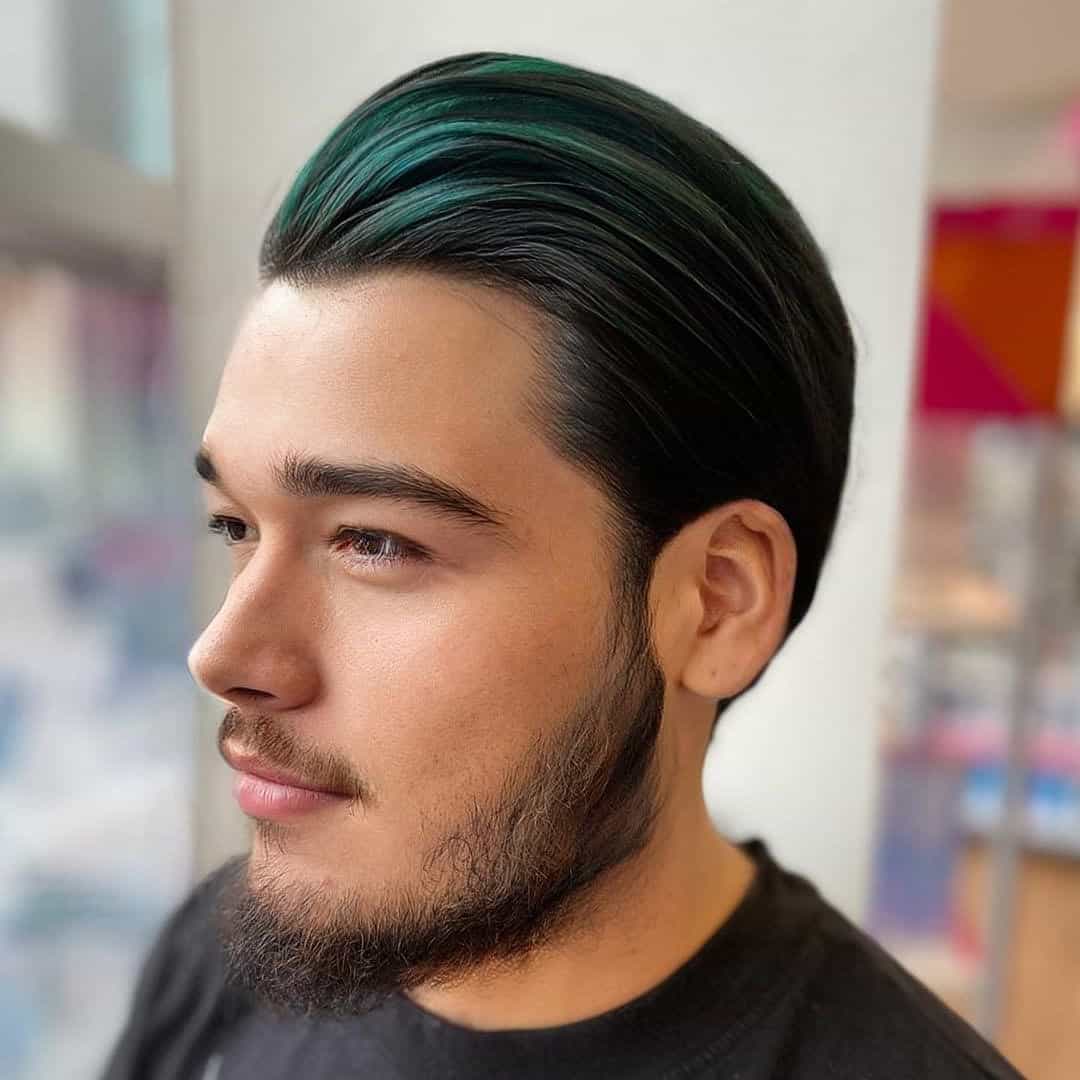 man with alpine green hair highlights