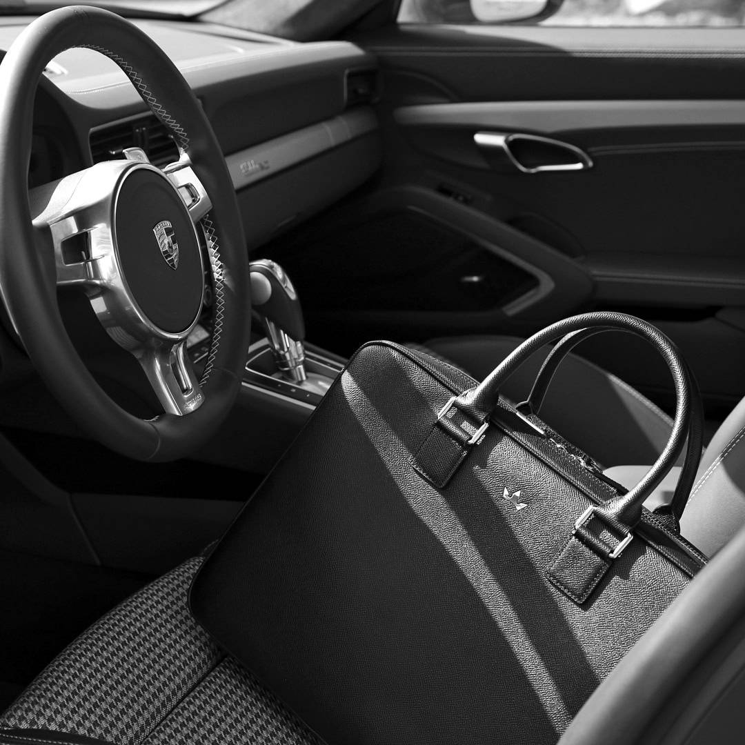 a roderer award briefcase in the drivers seat of a car