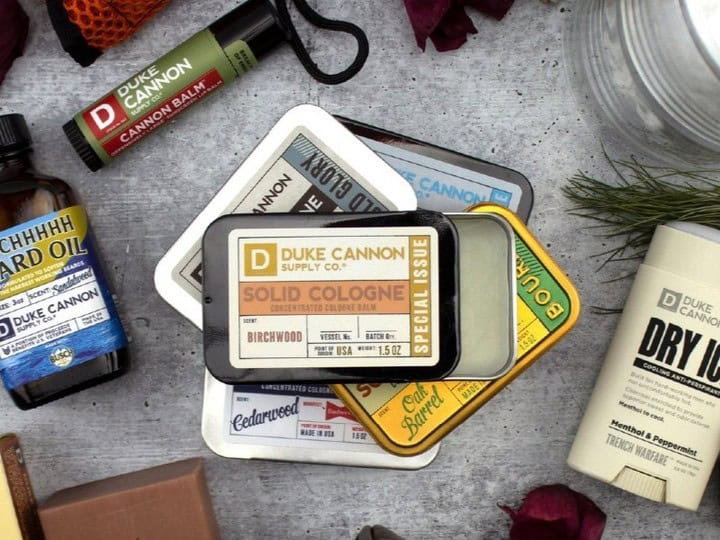 a pile of duke cannon solid colognes