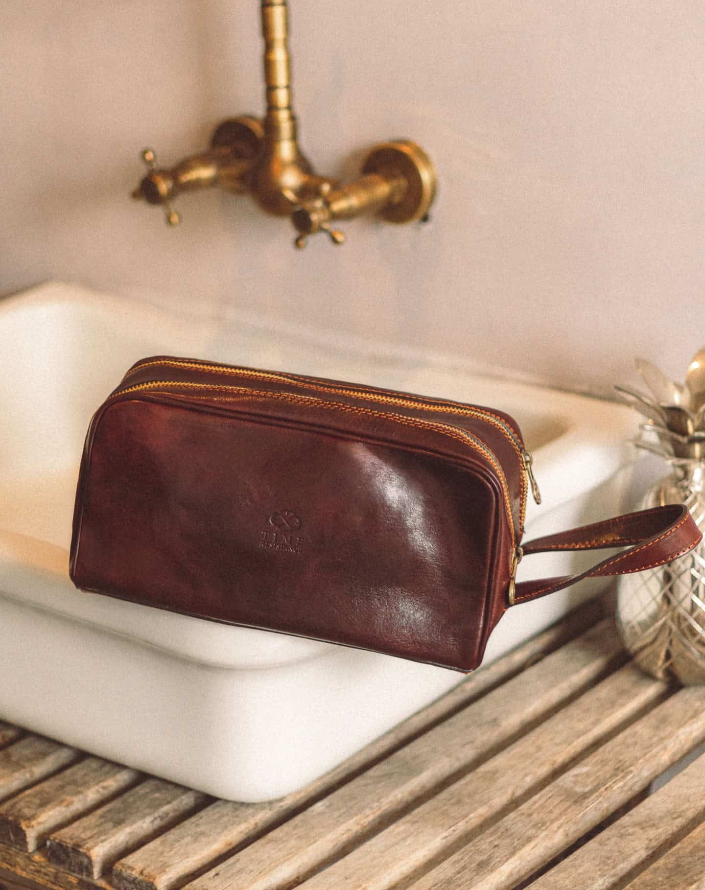 a leather cosmetic bag on the sink by time resistance