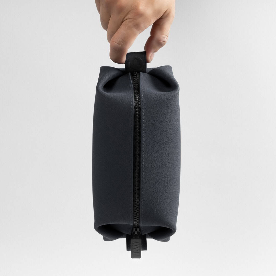 holding the koby dopp kit by tooletries