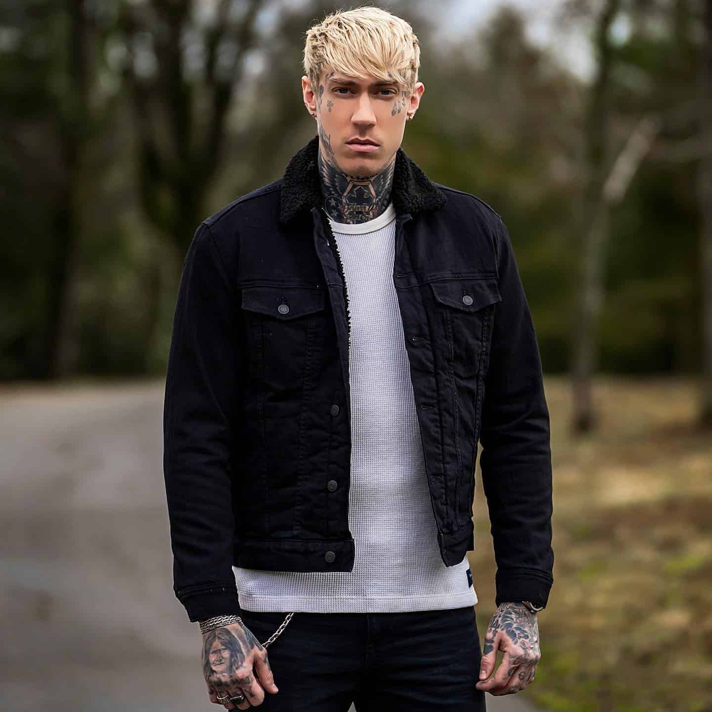 trace cyrus wearing a black denim jacket