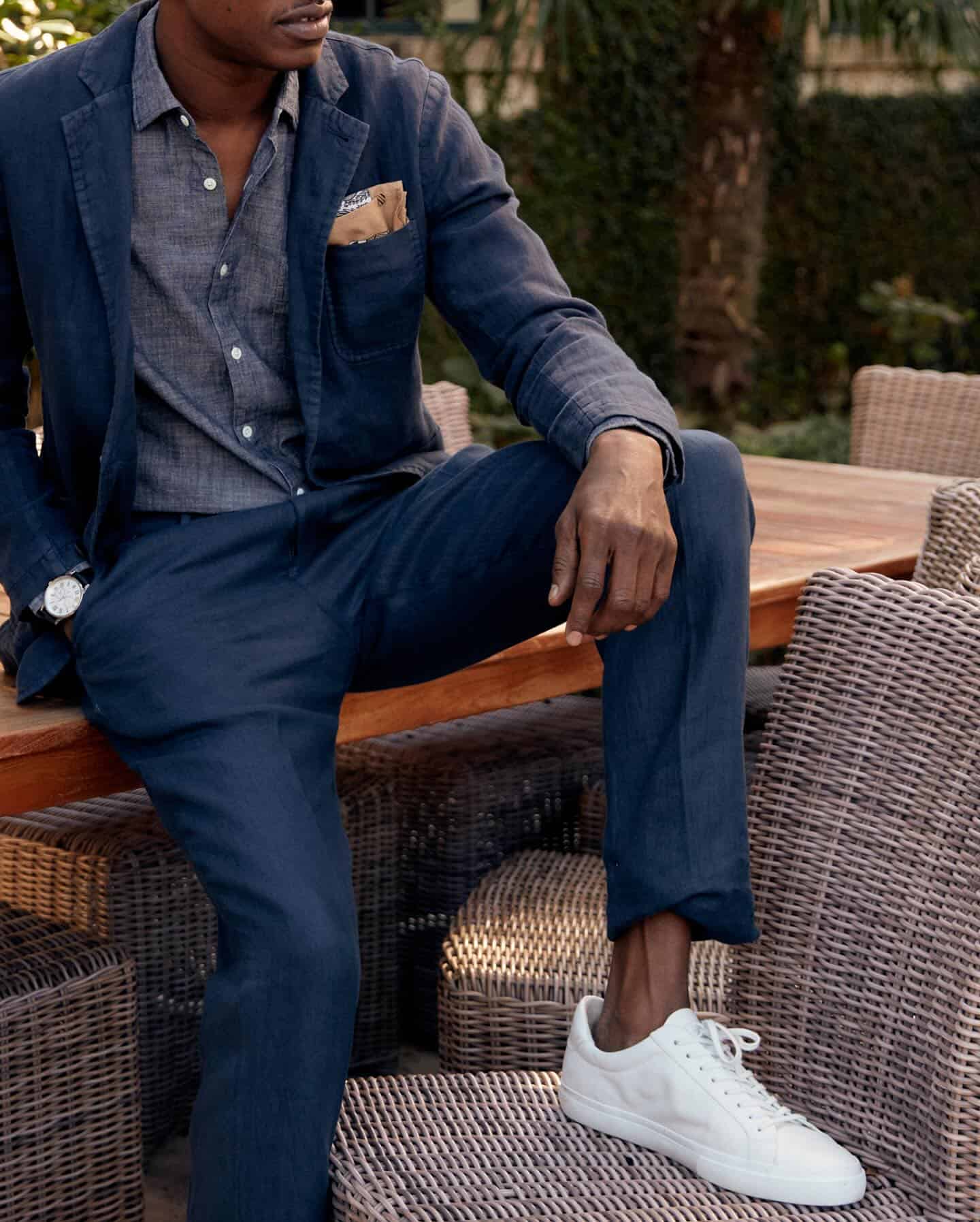 man wearing a suit over a chambray shirt