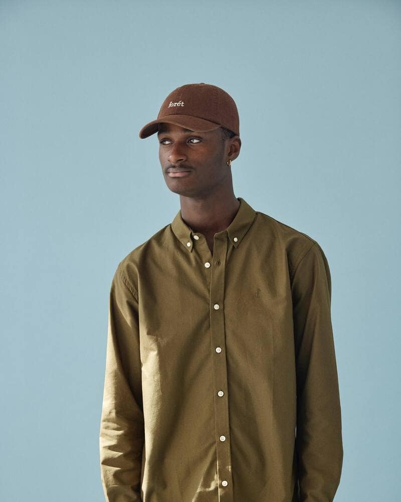man wearing a brown hat and an olive green shirt