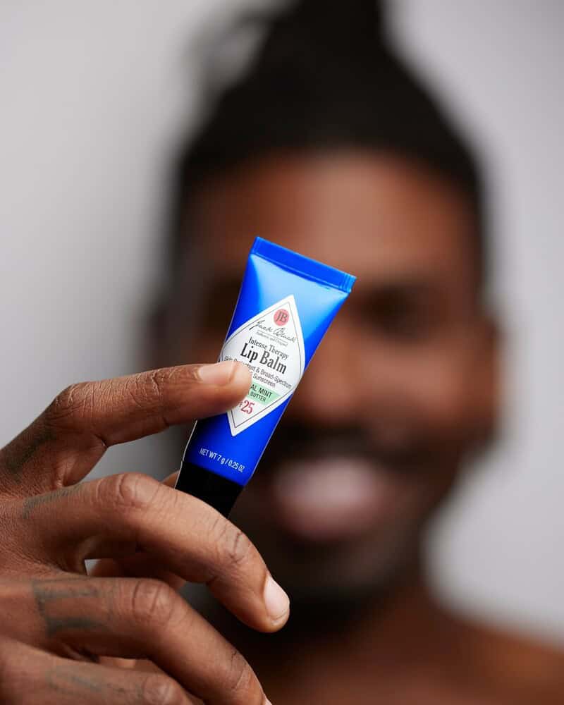man holding a black jack lip balm