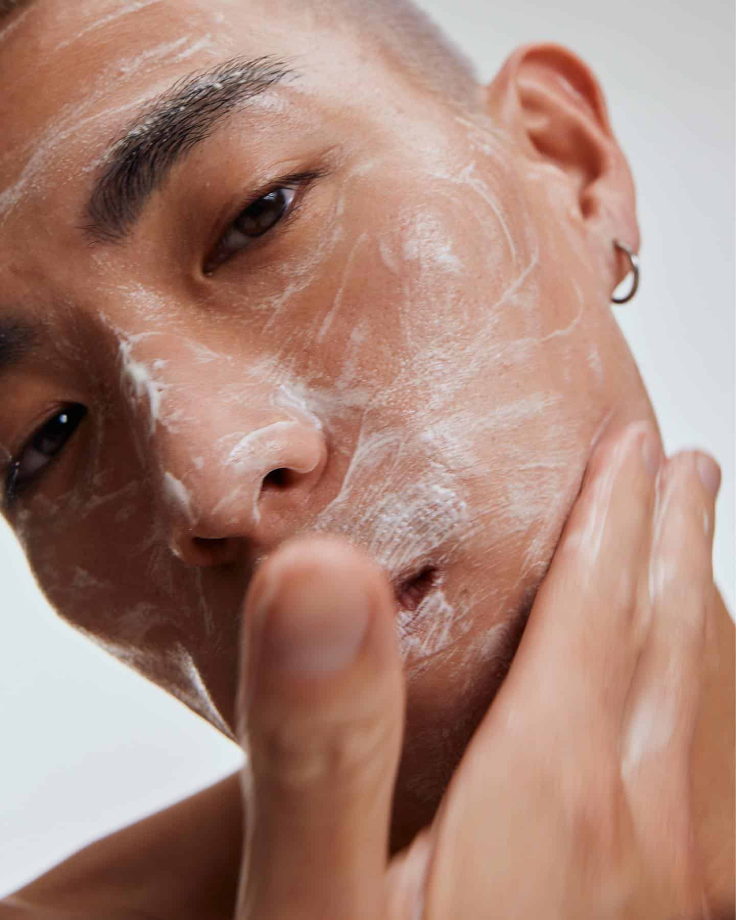 man applying cream to his face