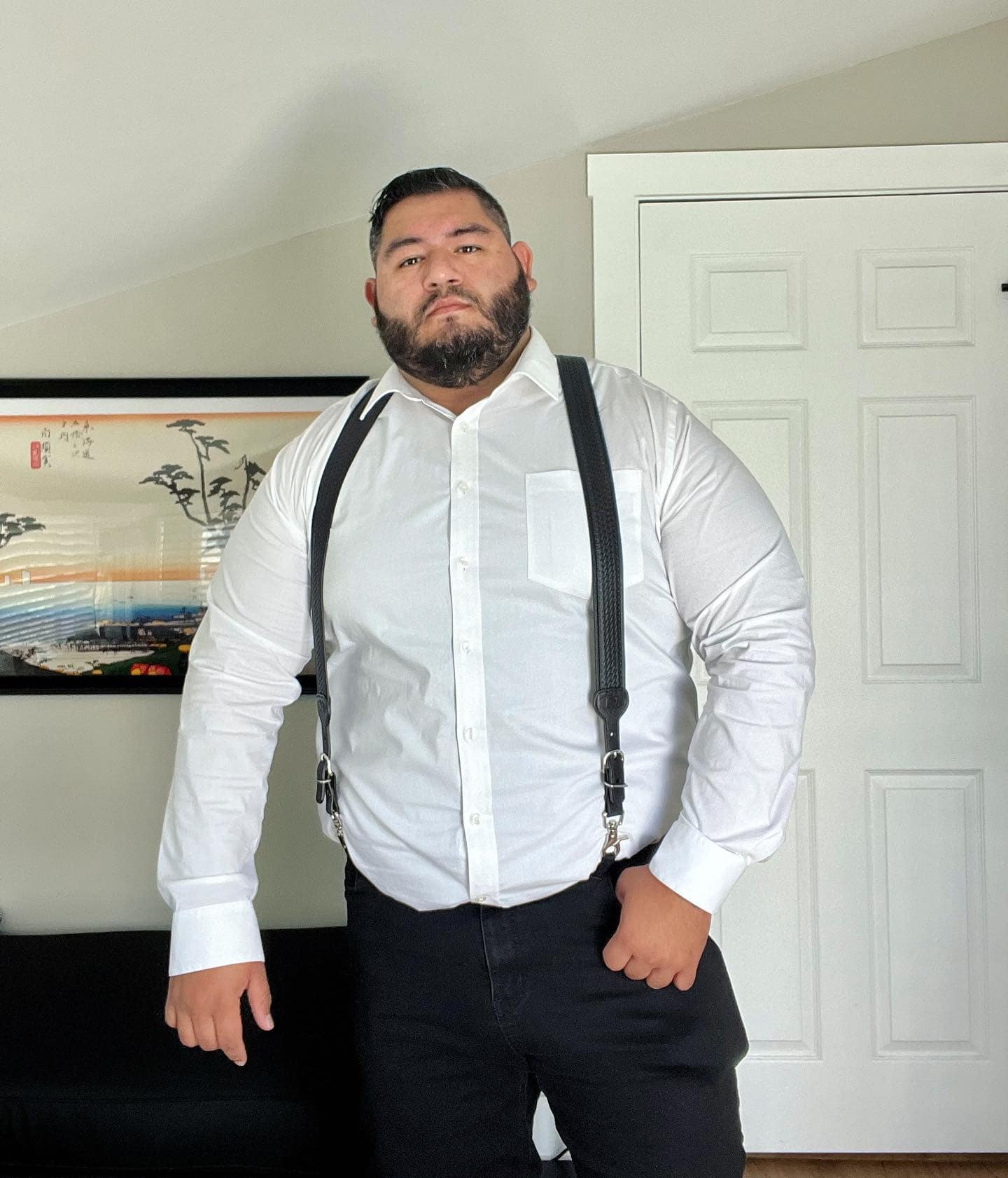 man wearing white shirt with suspenders