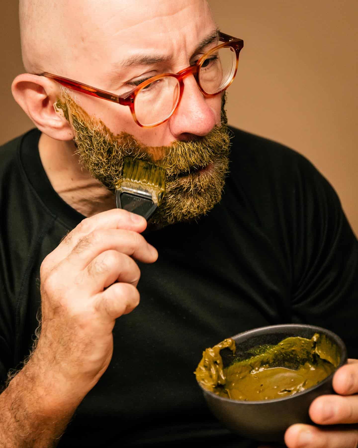 man applying an organic beard dye by grizzly mountain on beard
