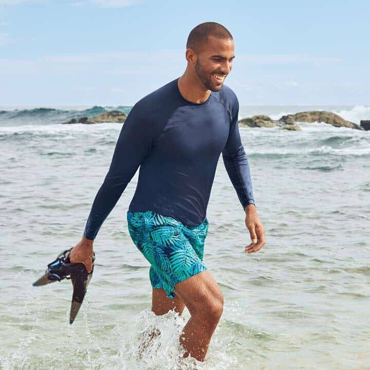 man walking towards the shore