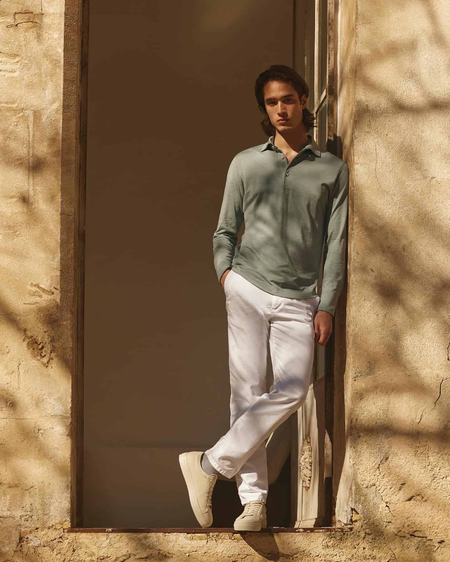 man wearing the silk cotton long sleeved polo shirt by loca faloni