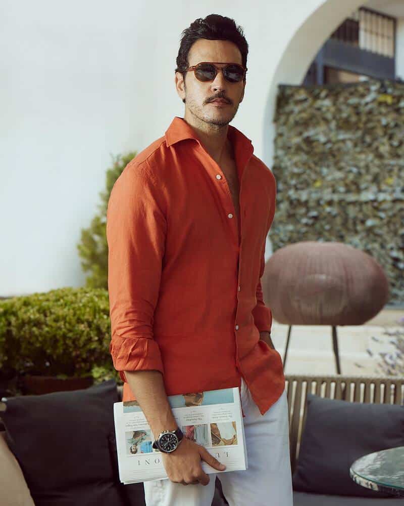 man with sunglasses wearing a dark orange shirt