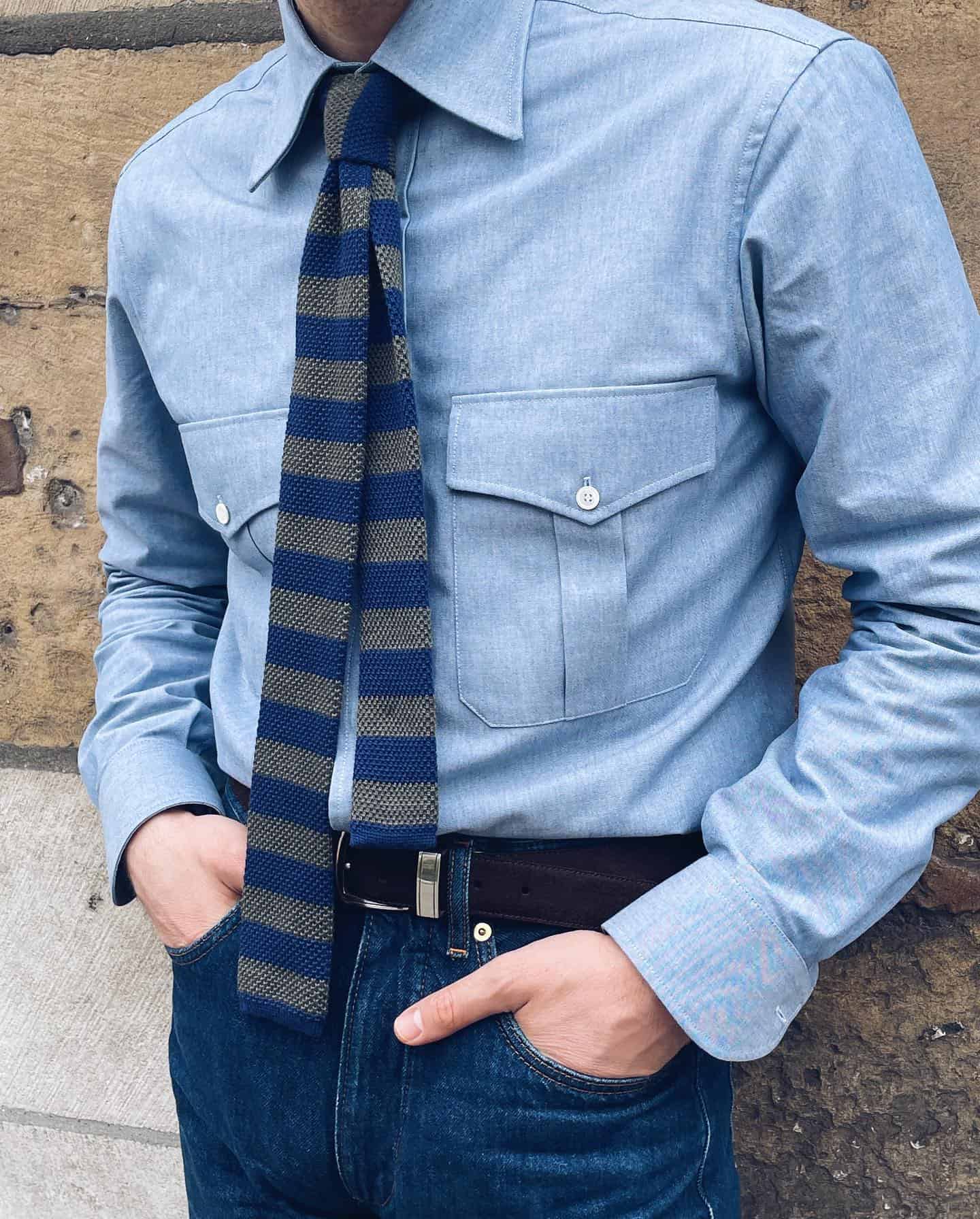 man wearing a chambray shirt with a knitted tie
