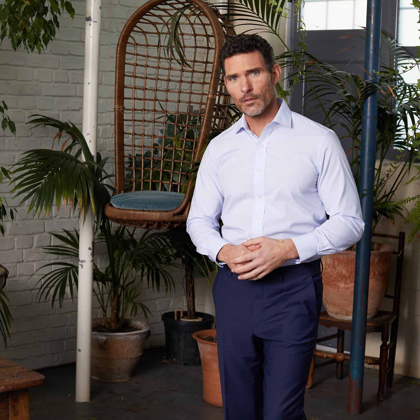 man wearing a white shirt and navy pants