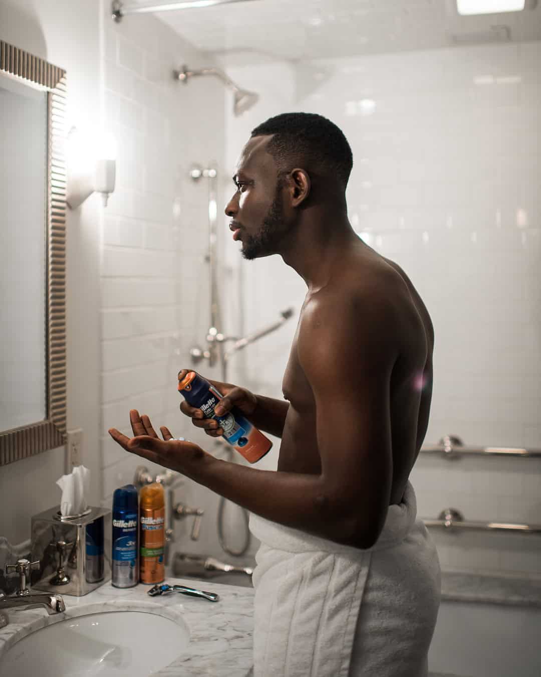 squeezing a handful amount of gillette shave gel