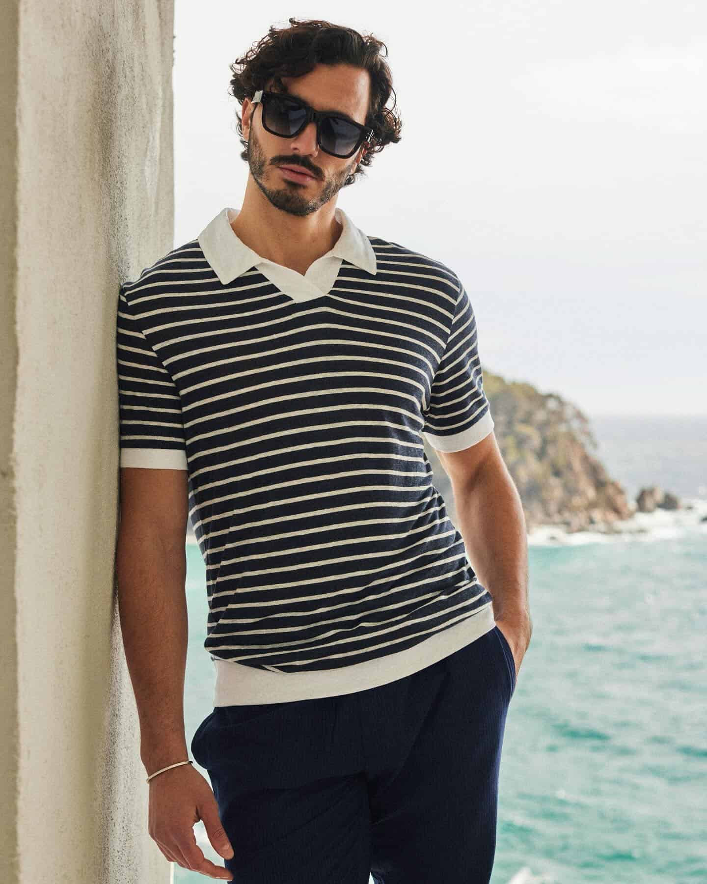 man wearing the navy striped polo shirt by The Resort Co