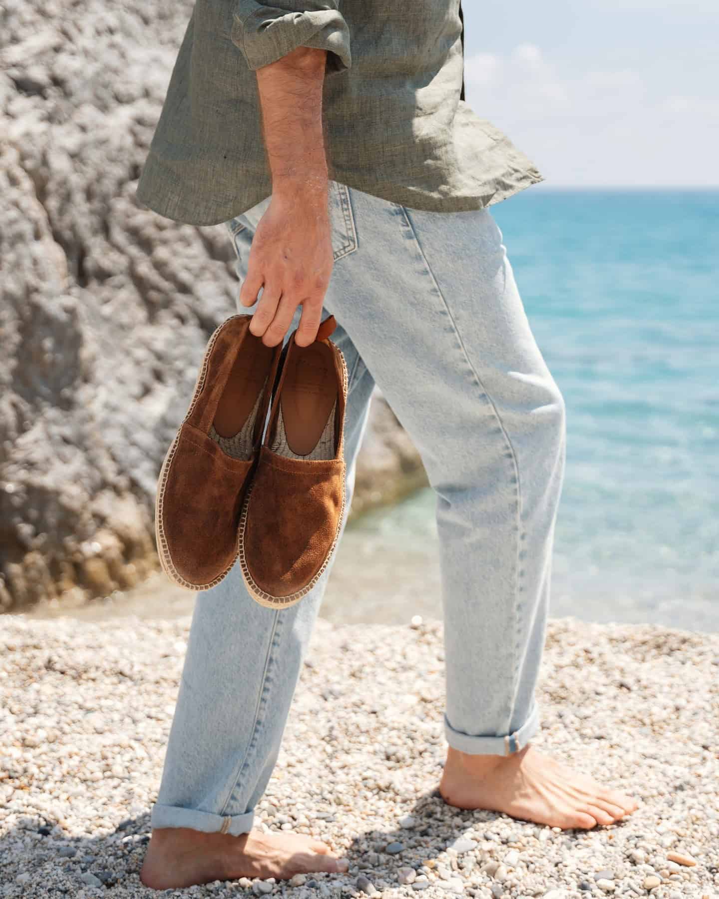 man carrying a pair of velasca inguriatt espadrilles