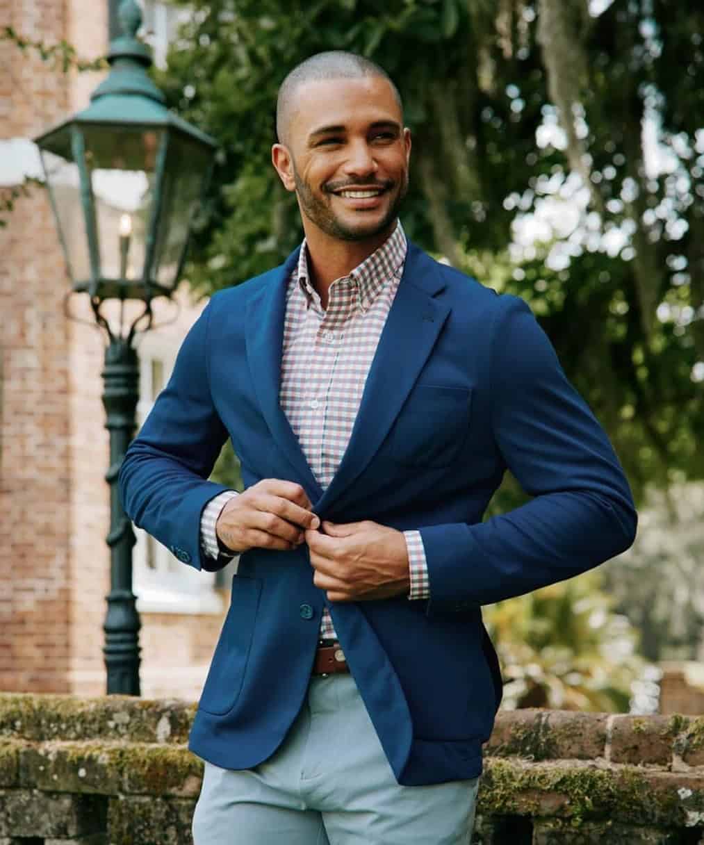 man wearing a checked shirt under a blue blazer