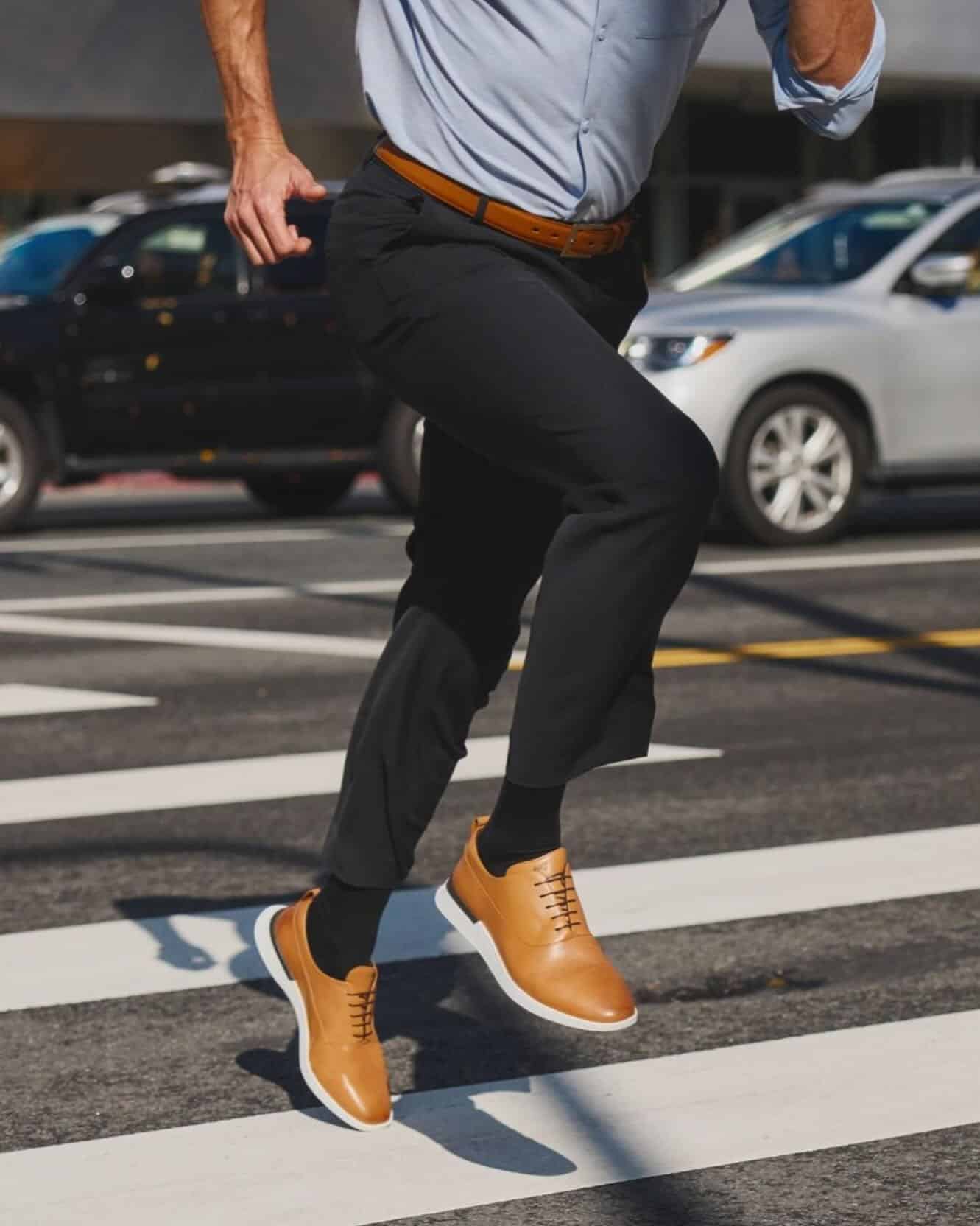 man running on a crosswalk wearing a pair of crossover longwing by wolf and shepherd