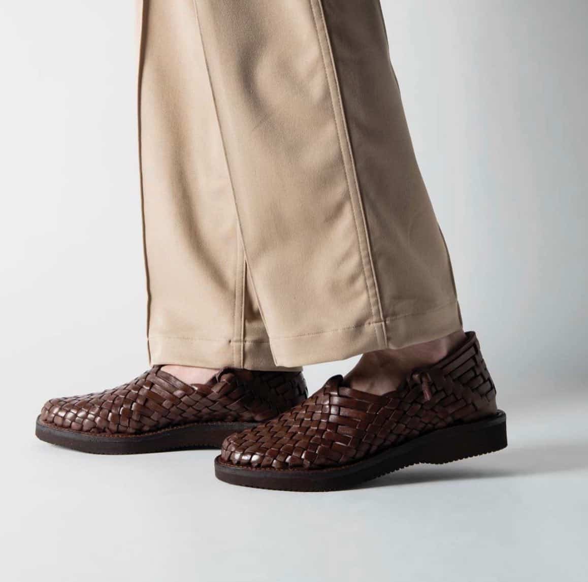 wearing a pair of yuketen leo woven leather sandals