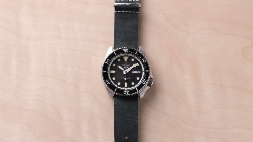 A seiko 5 watch with a one piece lather strap