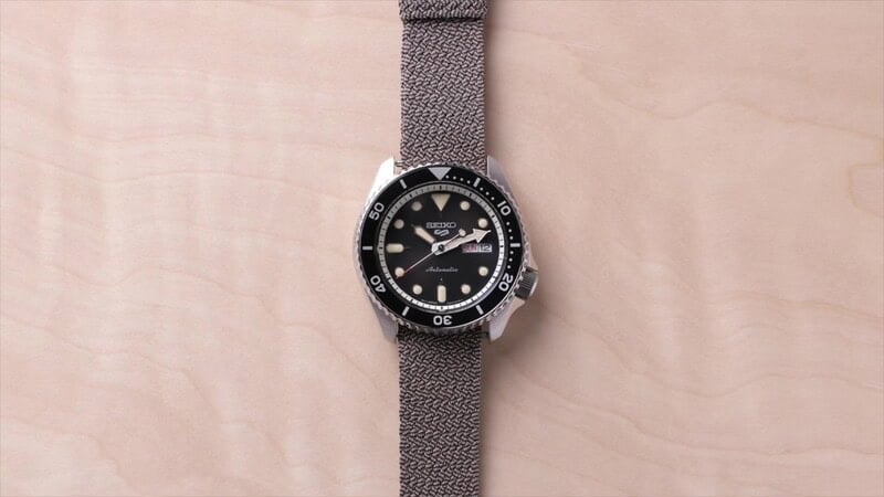 A seiko 5 watch with perlon straps