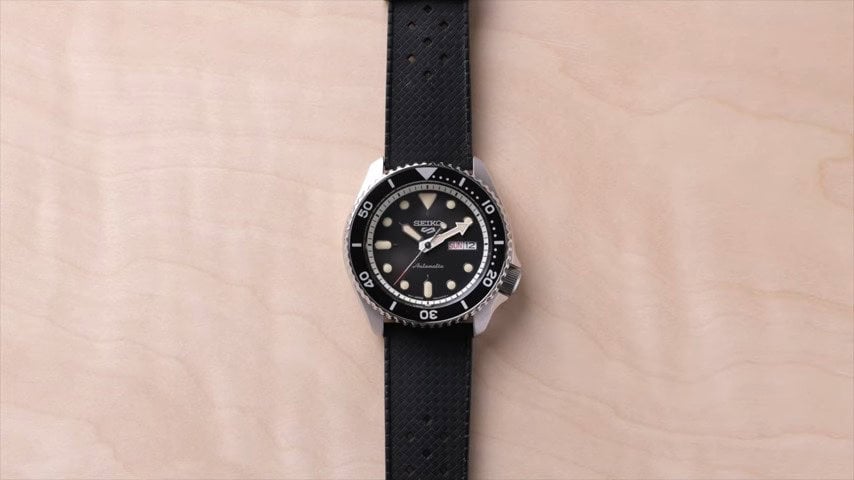 A seiko 5 watch with rubber straps