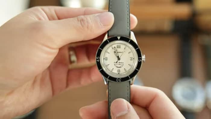 holding a watch with a Grey Artem Hydroflex strap